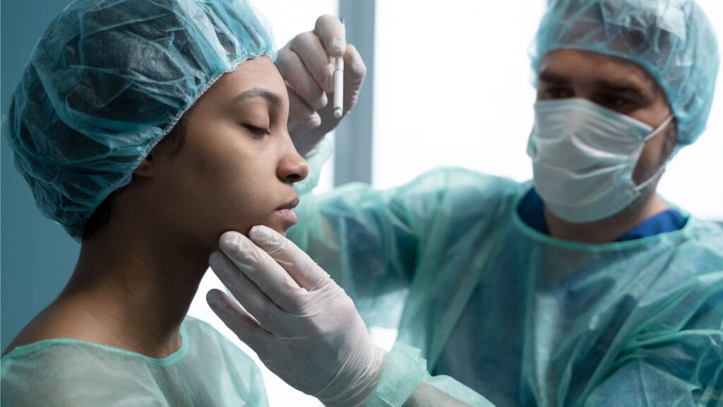 Nose Reshaping Surgery Procedure consultation showing a surgeon evaluating nasal structure before rhinoplasty surgery